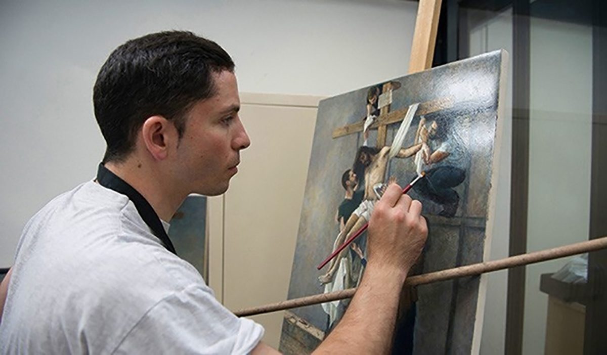 Художник в своей мастерской работает над циклом картин